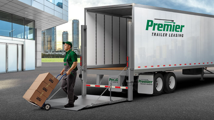 Delivery driver using a liftgate to unload boxes from a premier truck 